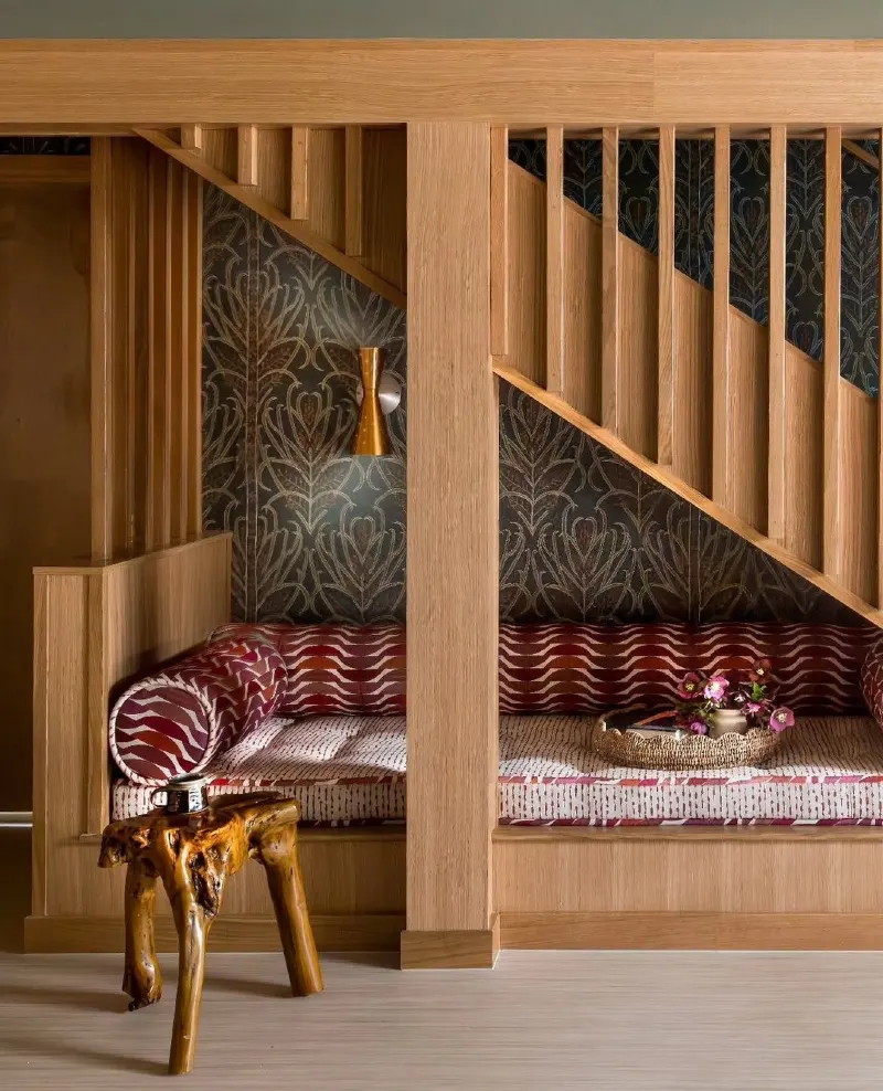 Oak-Framed Daybed with Patterned Damask Wallpaper and Crimson Textiles