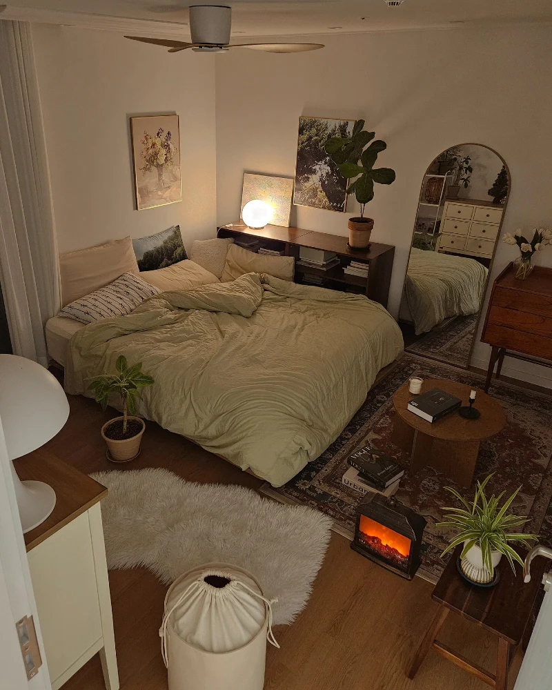 Olive Green Bedding Bedroom with Fireplace Glow and Mirror Depth Corner