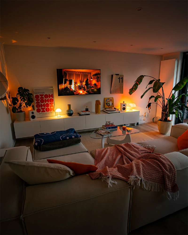 Orange Ambient TV Glow Living Room with Modular Sectional and Modern Media Wall