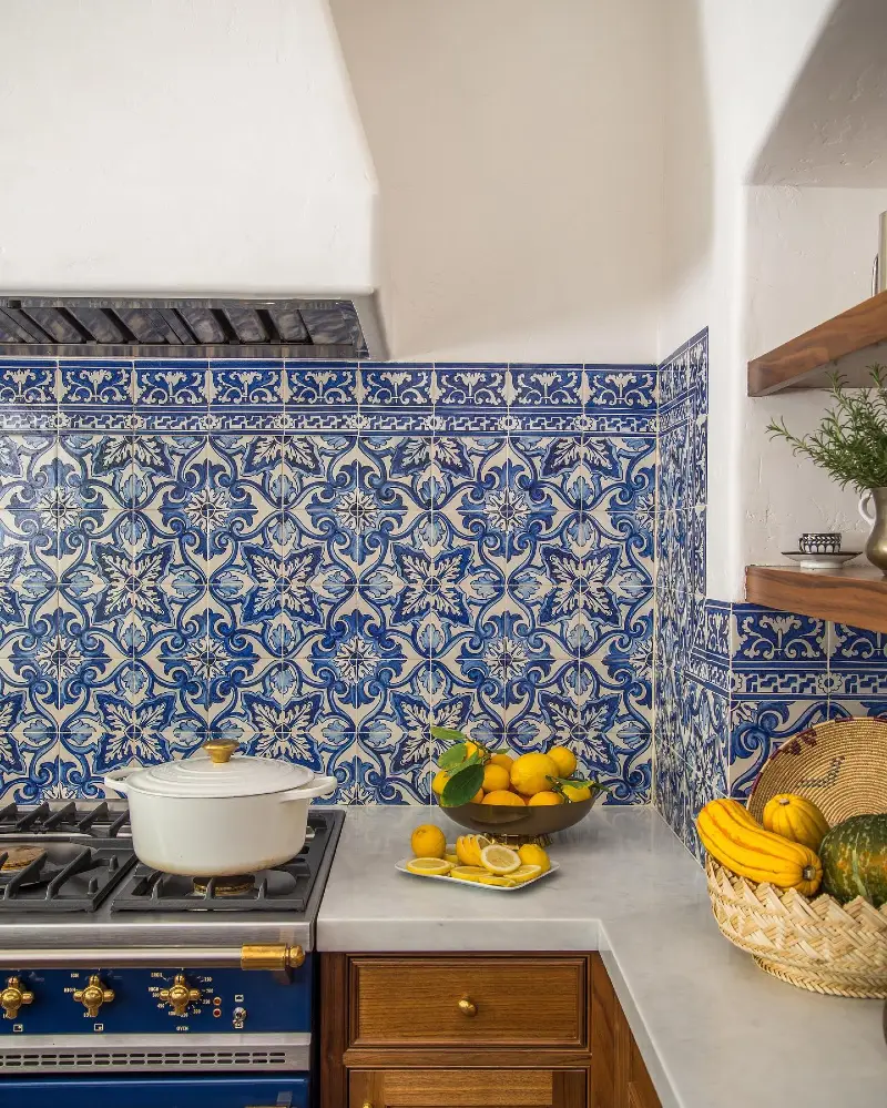 Ornate Blue Spanish Tile Backsplash with White Cabinets and Rustic Wood Counter Corner