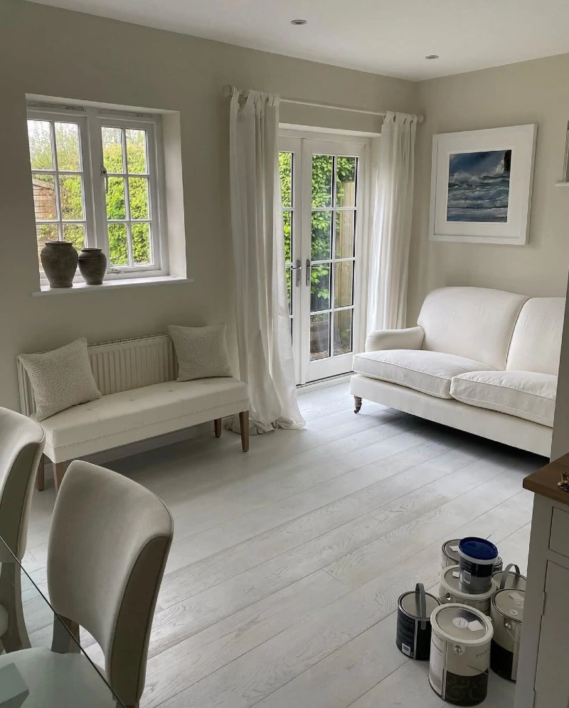 Pale Sitting Room with Sheer Curtains and Garden Doors