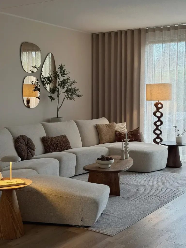 Pebble Mirror Trio with Curved Cream Sectional and Wavy Rug