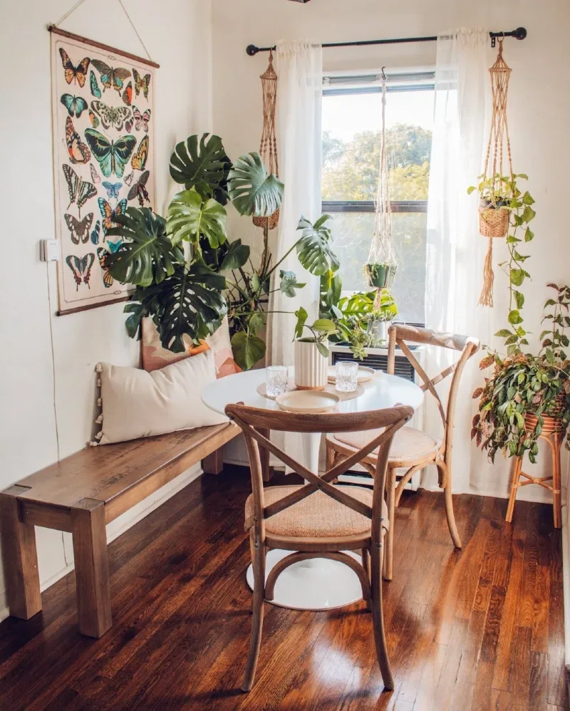 Plant-Filled Bistro Nook with Butterfly Wall Hanging and Wood Bench