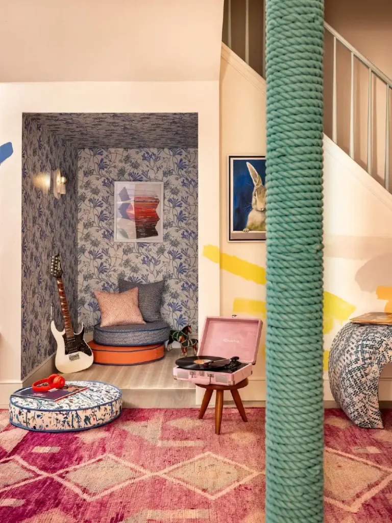 Playful Blue Floral Wallpaper Nook with Stacked Floor Cushions and Record Player