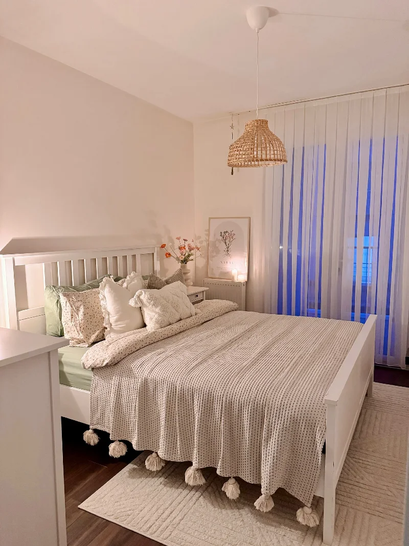 Rattan Pendant Glow Over Soft Green Scandinavian Bedding