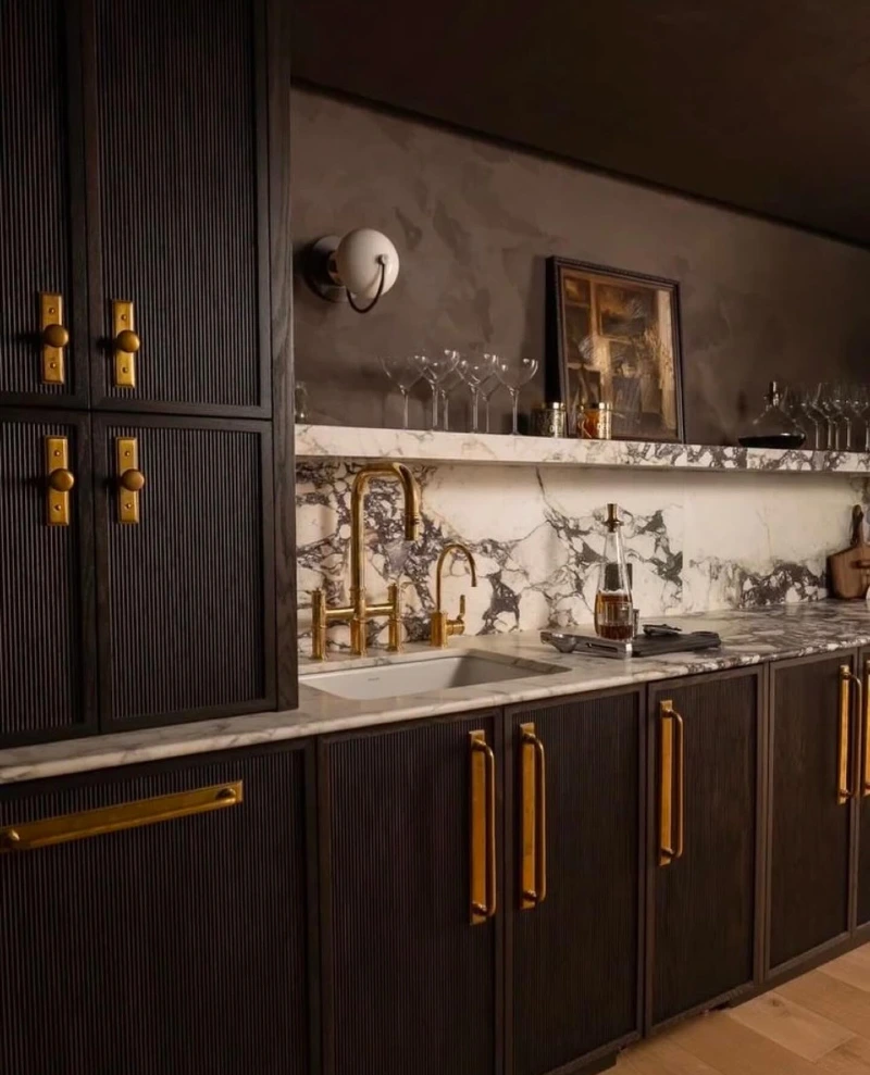 Reeded Charcoal Cabinetry With Calacatta Viola Marble and Chunky Brass Hardware