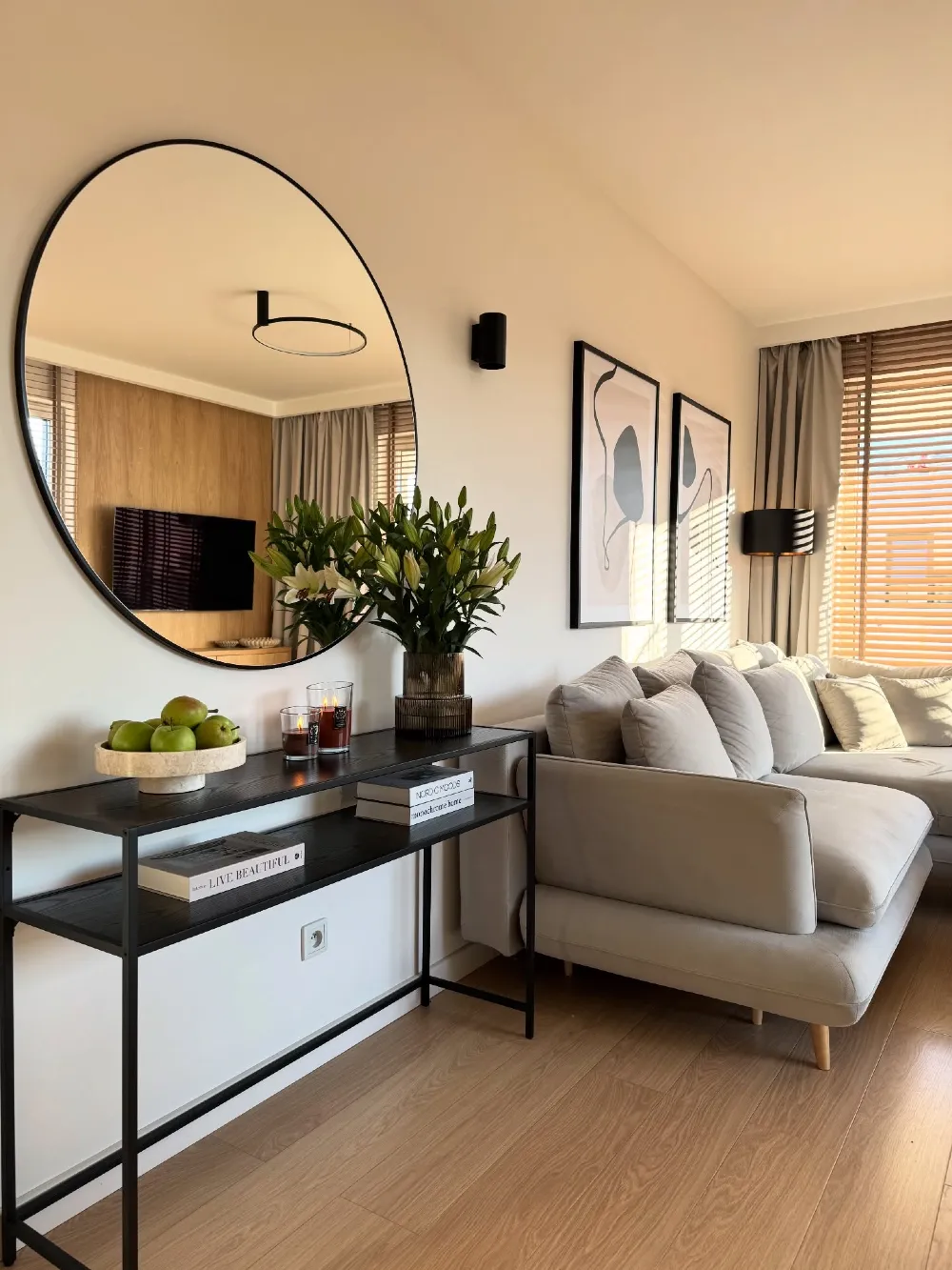Round Mirror Console Table with Black Frame Styling and Fresh Green Apple Bowl Accent