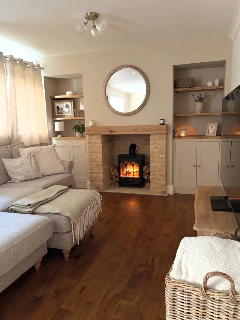 Rustic Brick Fireplace with Round Mirror, Oak Beam Mantel, and Black Wood Stove