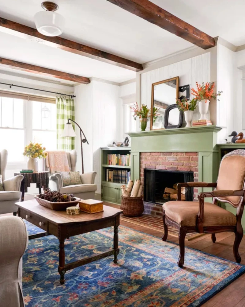 Sage Green Mantel with Brick Firebox, Layered Mirrors, and Orange Branches