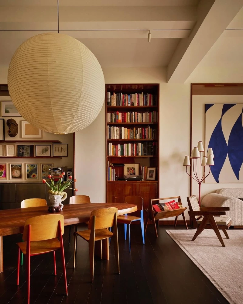 Sculptural Paper Pendant with Bookshelf Dining Nook and Warm Modern Collectible Seating