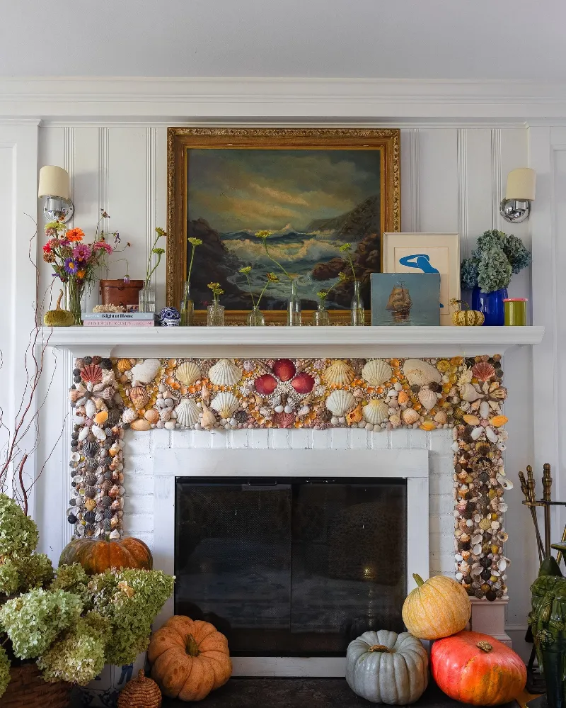 Seashell Fireplace Surround with Seascape Art, Bud Vases, and Harvest Pumpkins