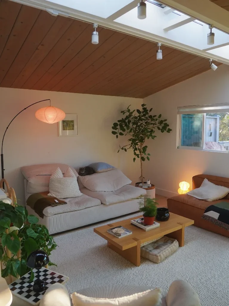 Slanted Wooden Ceiling with Low-Profile Sofas and Skylight