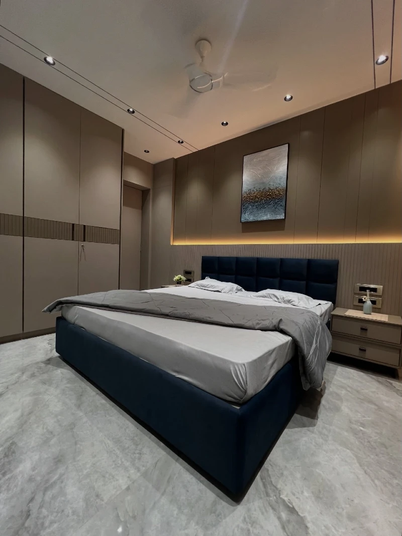 Soft Beige Panel Bedroom with Deep Blue Base and Warm Cove Lighting