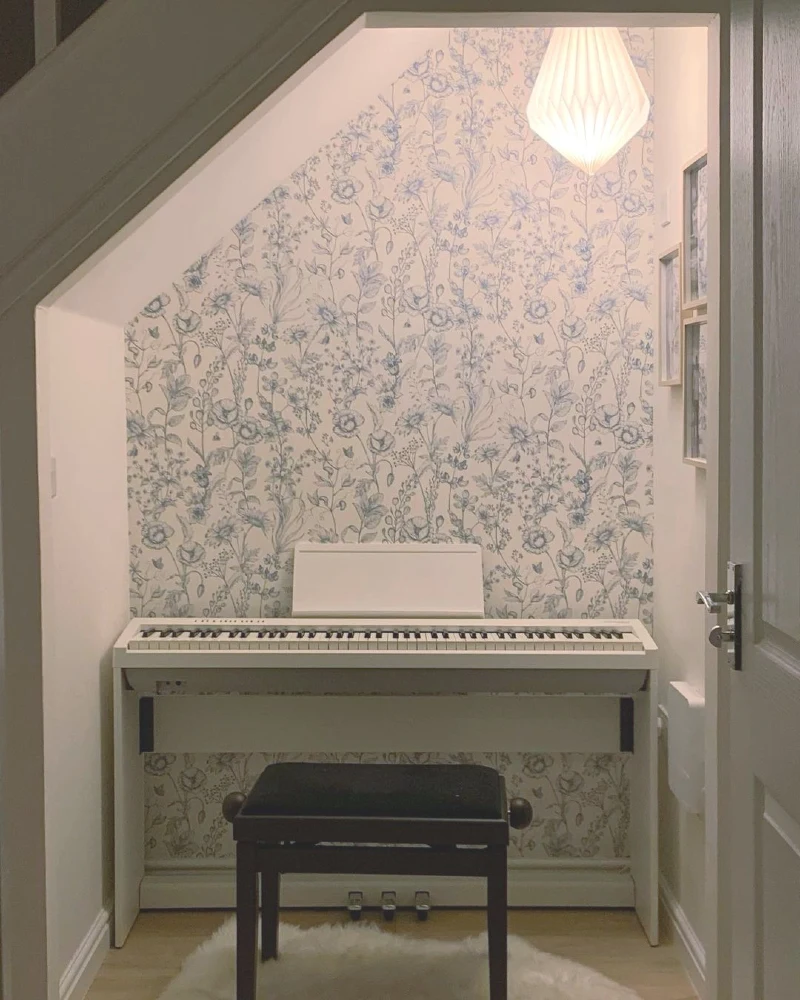 Soft Blue Floral Wallpaper Nook with White Digital Piano and Origami Pendant
