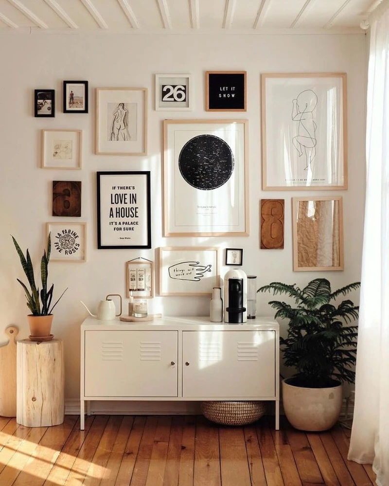 Soft Minimal Gallery Wall Above Cabinet with Balanced Black, Wood, and Neutral Frames