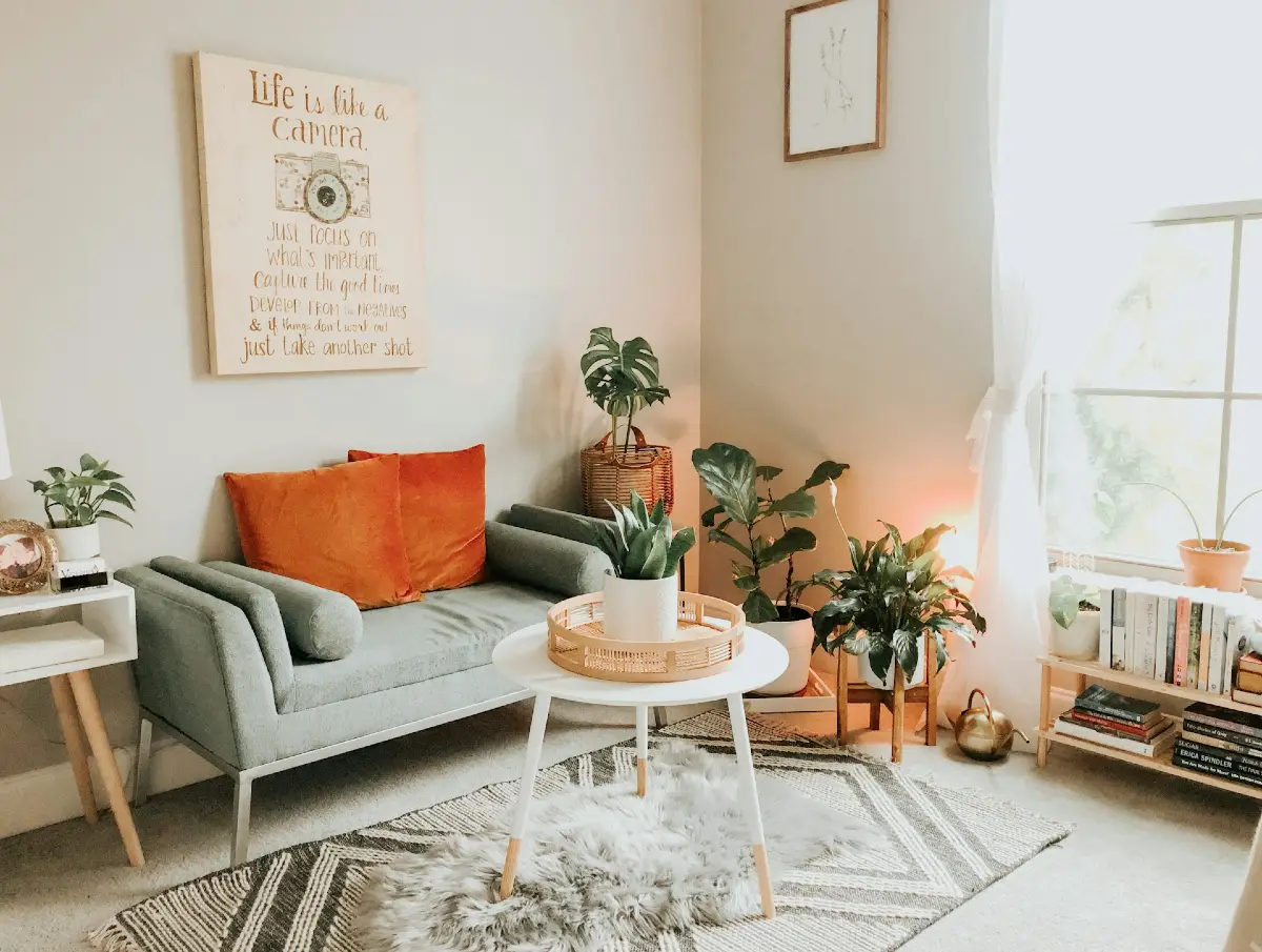 Soft Reading Nook with Layered Houseplants and Warm Accent Pillow
