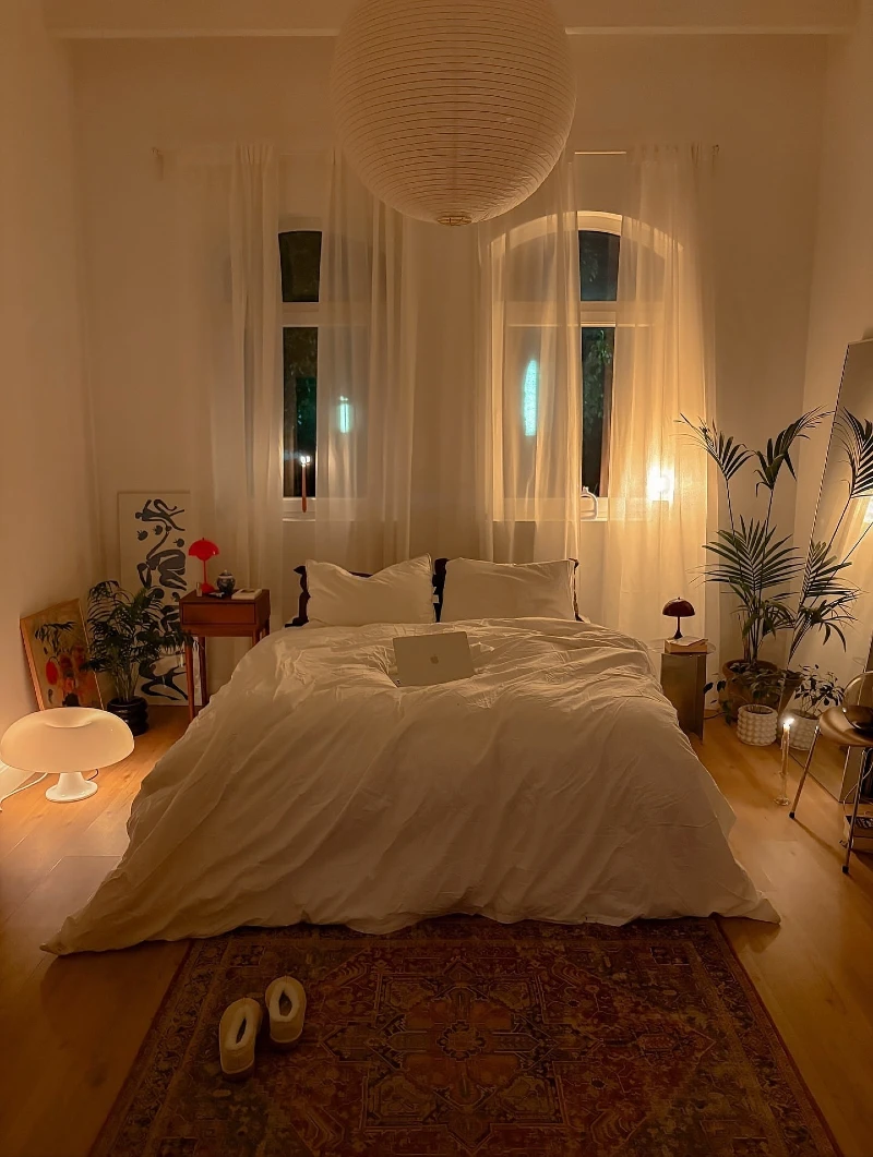 Soft White Linen Bedroom with Sheer Curtains and Paper Lantern Glow