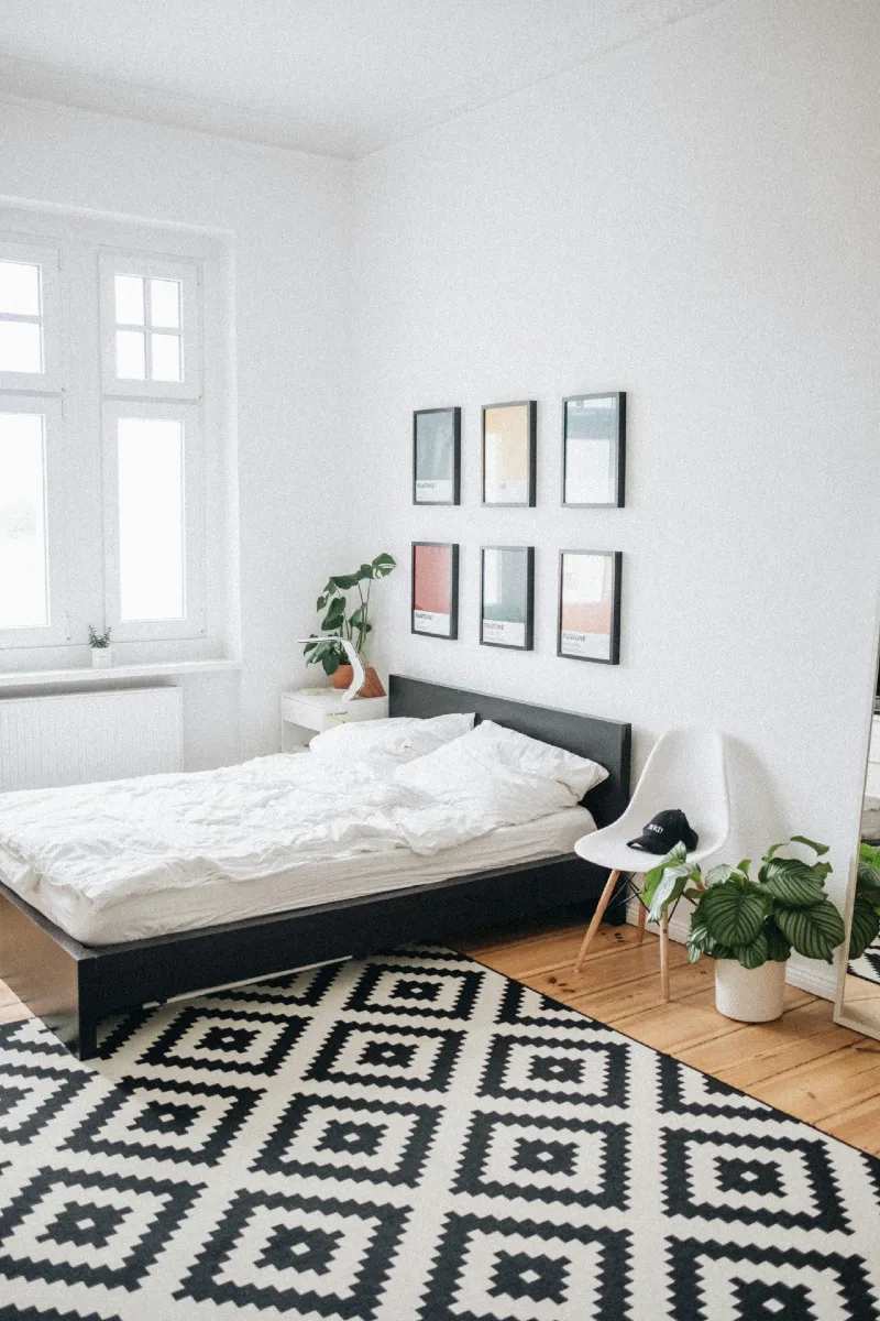 Soft White Studio with Geometric Rug and Clean Minimal Wall Grid