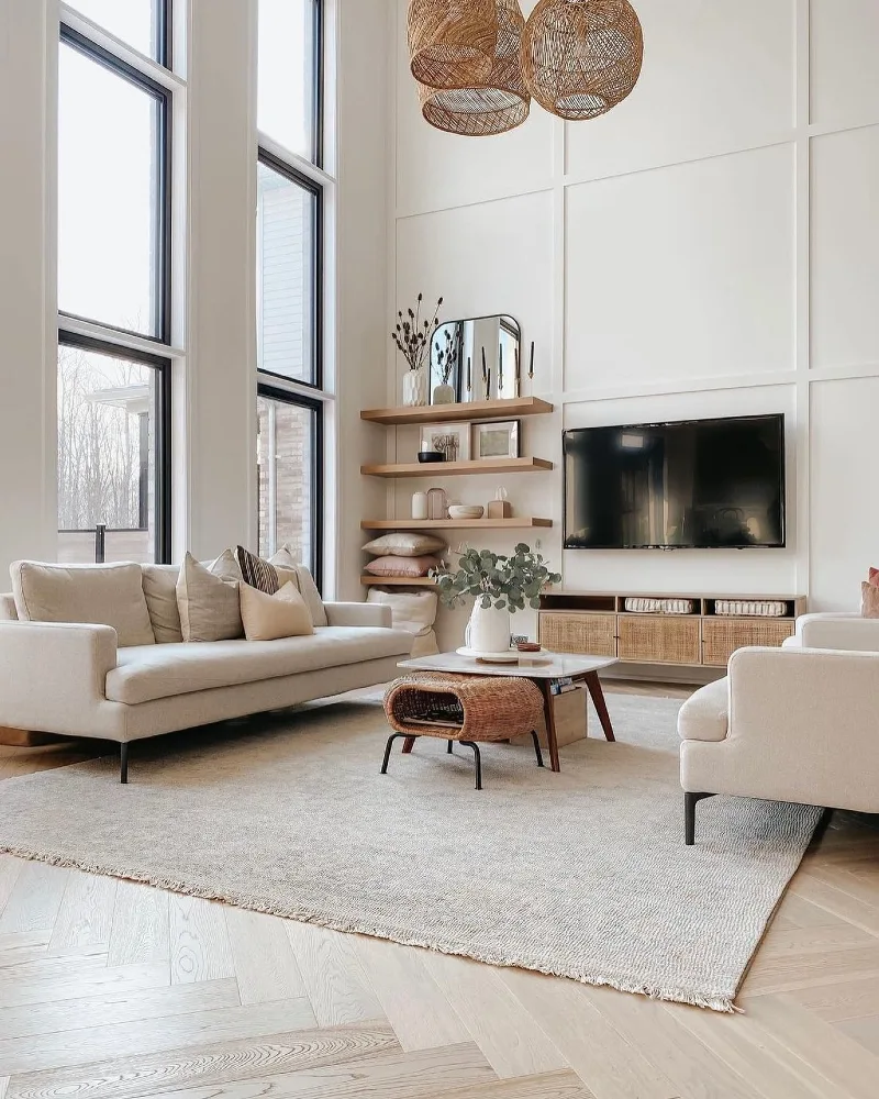 Tall White Panel Walls with Rattan Pendants and Low Linen Seating