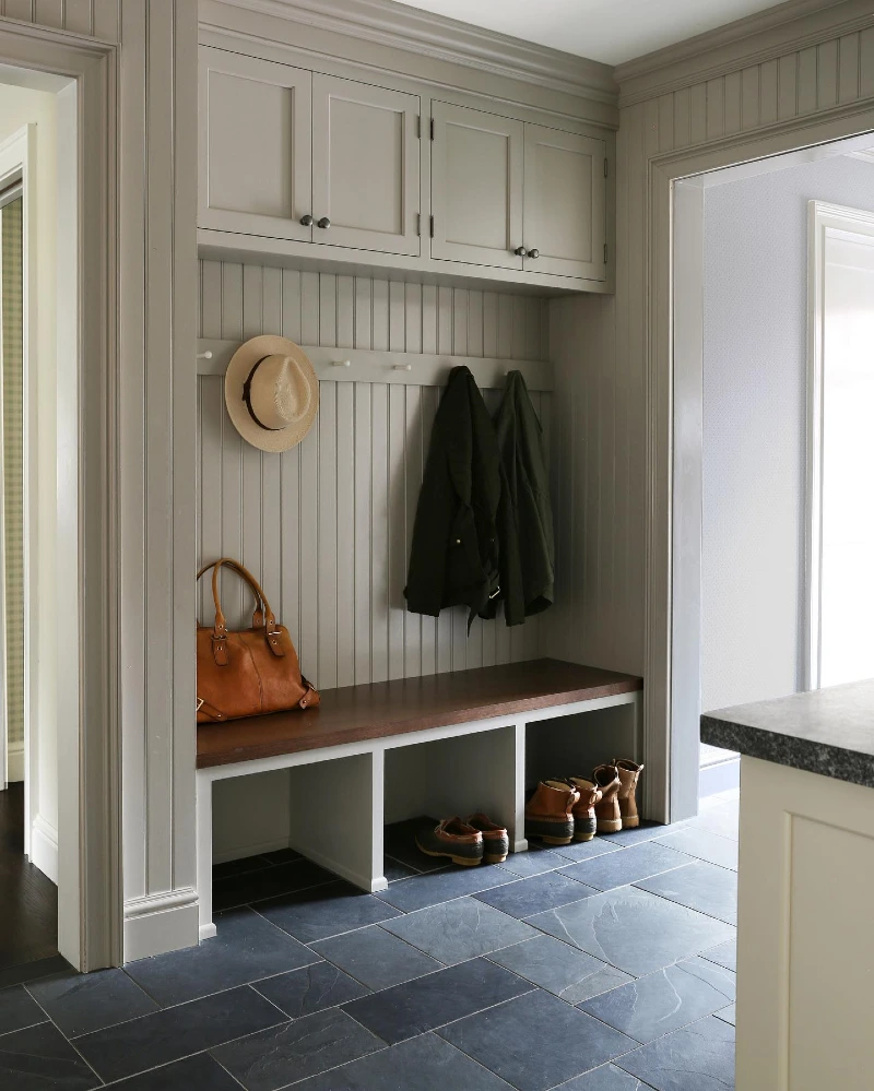 Taupe Built-In Mudroom Unit with Beadboard Backing and Slate Tile Flooring