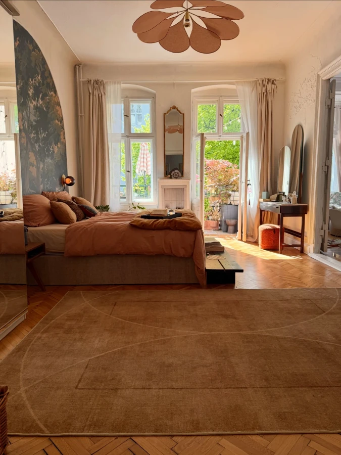Terracotta Bed with Arched Windows and Floral Ceiling Light