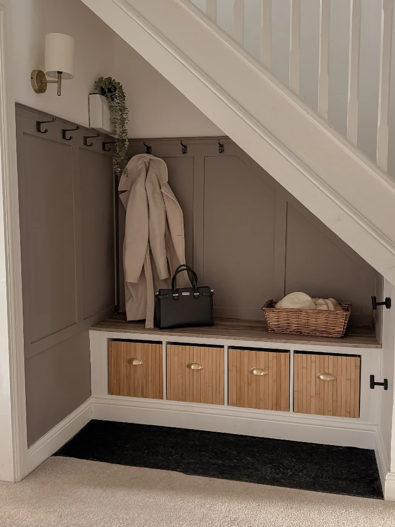 Under-Stairs Taupe Paneling with Reeded Storage Bins and Brass Cups