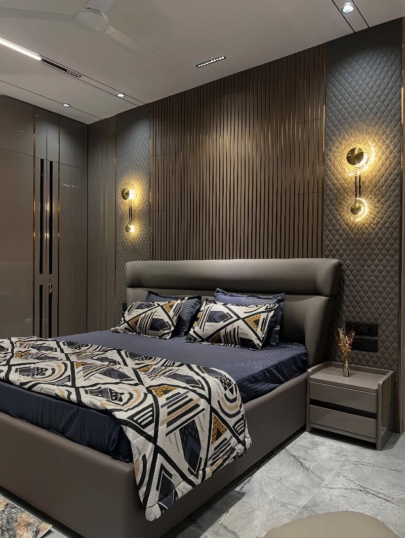 Vertical Slat Wood Wall Bedroom with Quilted Panels and Gold Circular Sconces