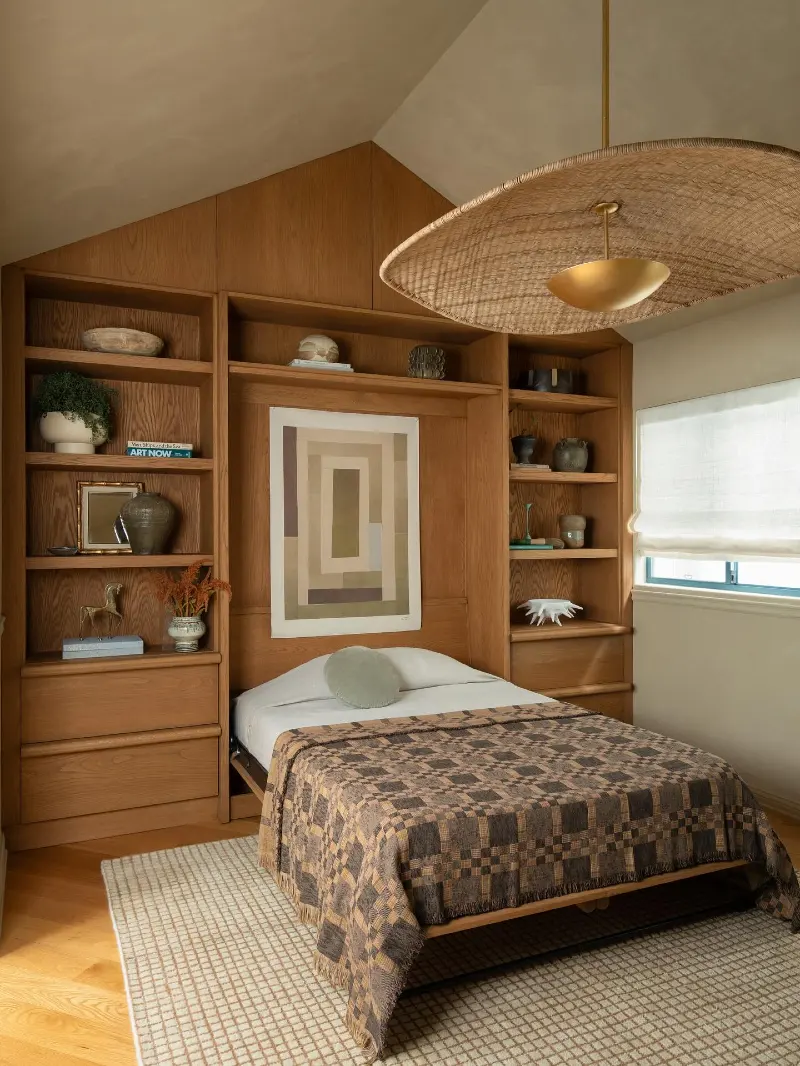 Warm Oak Vaulted Millwork with Woven Checkered Coverlet and Woven Hat Pendant Light