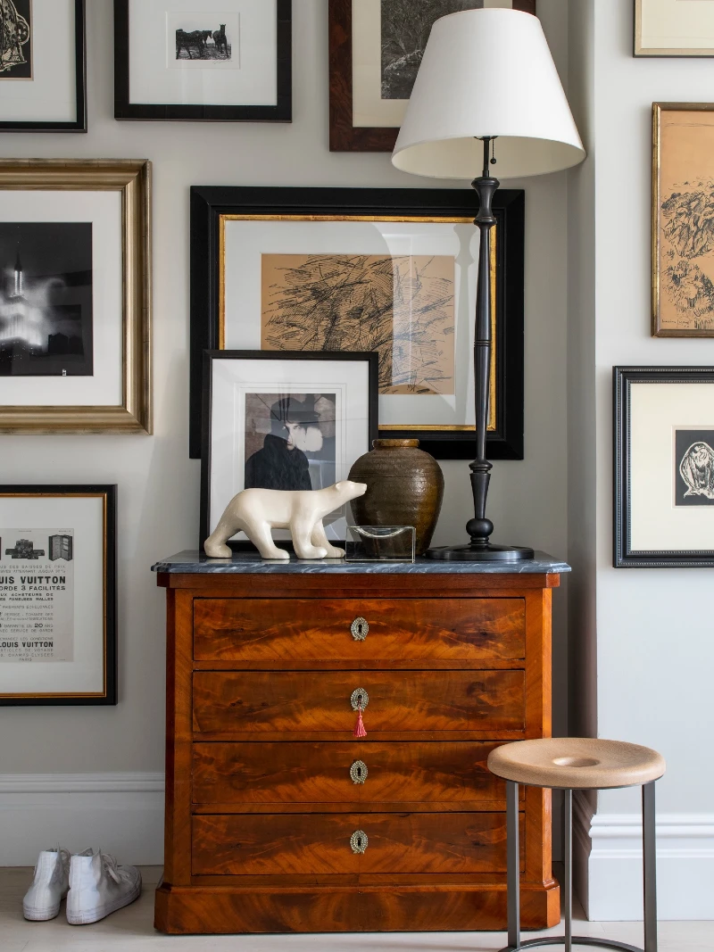 Warm Wood Dresser with Layered Black and Gold Frame Gallery