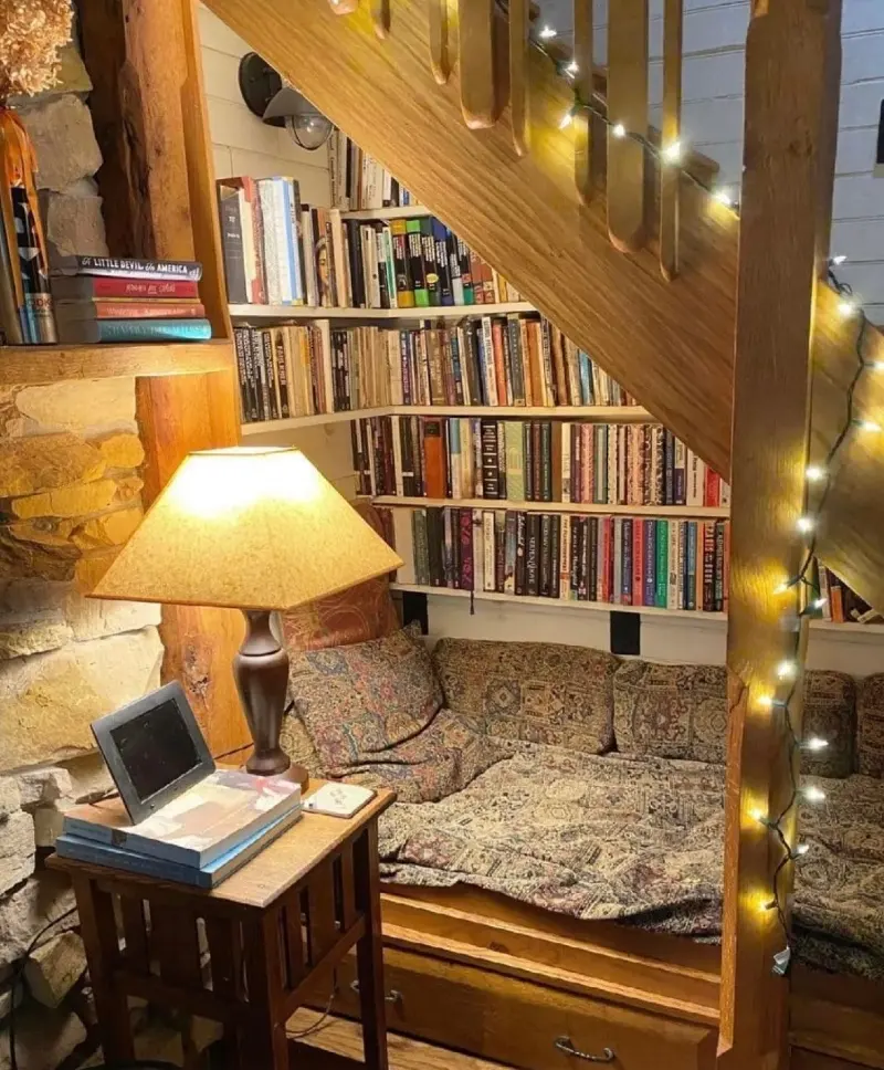 Warm Wood Reading Daybed with Built-In Bookshelves and Twinkling String Lights