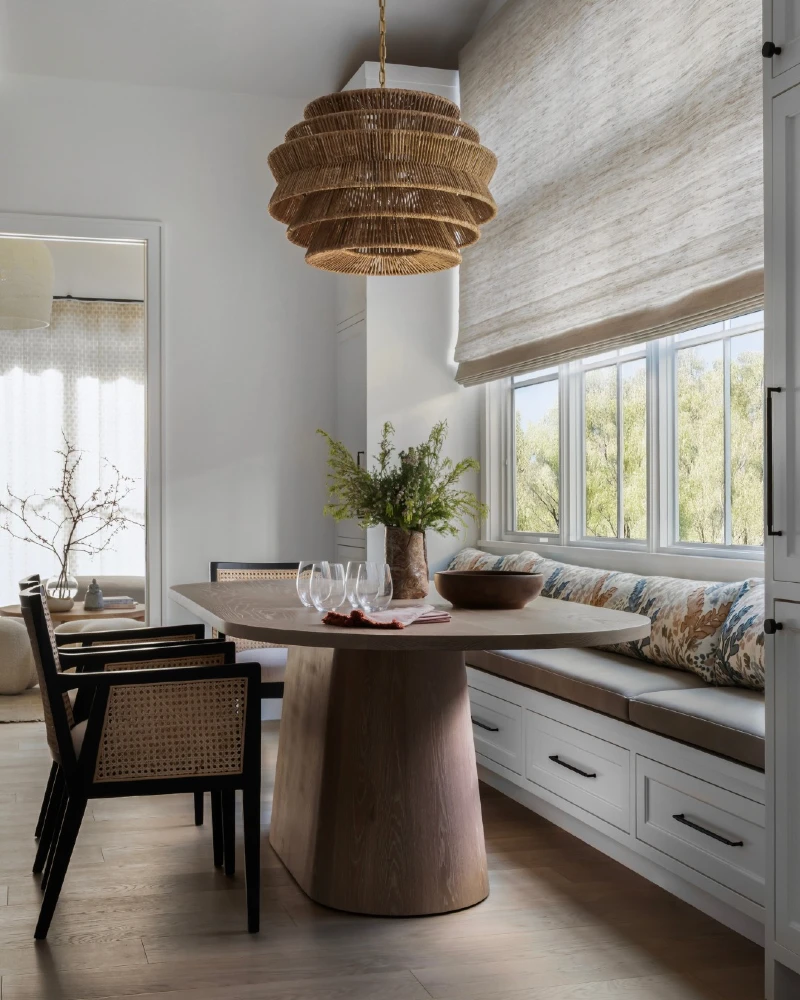 Window Banquette with Rattan Pendant and Cane Dining Chairs