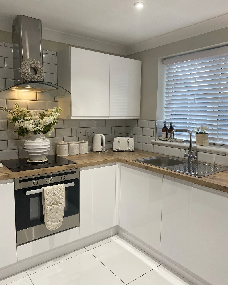 Wood Counter Corner with White Canisters, Kettle, Toaster, and Glossy Tile