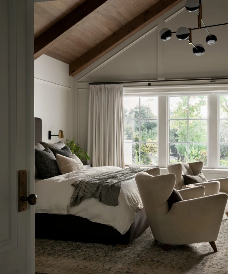 Wood Plank Vaulted Ceiling with Cream Wingback Chairs and Multi-Globe Chandelier
