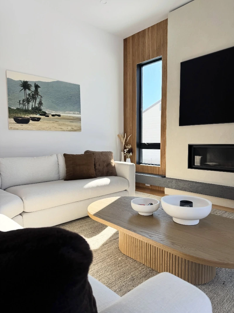 Wood Slat Window Wall with Oval Coffee Table and White Sofa