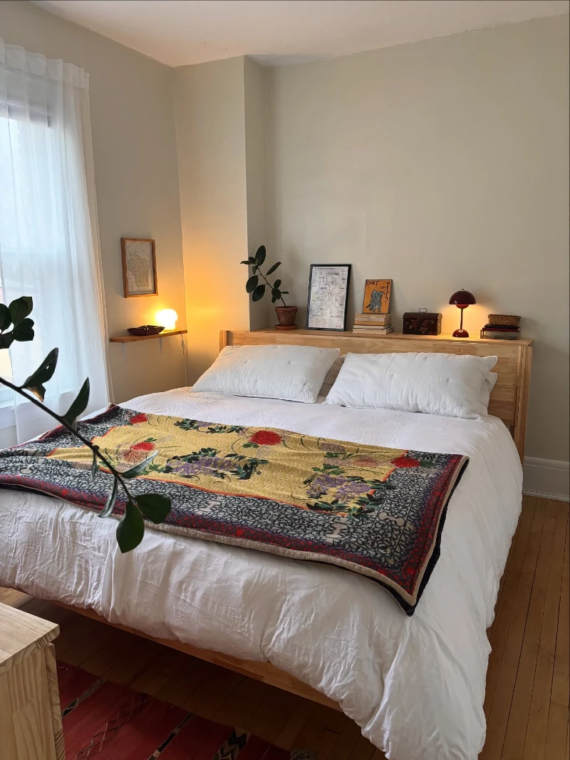 Wooden Headboard Shelf with Warm Bedside Lamps in Neutral Bedroom