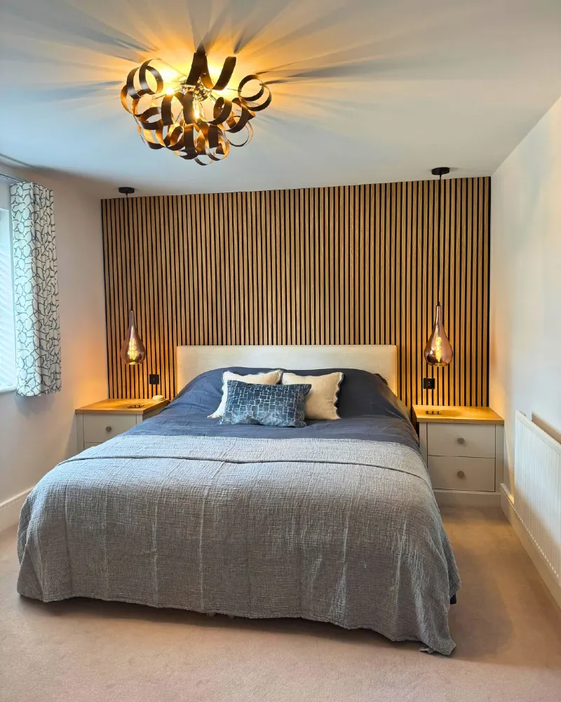 Wooden Slat Accent Wall with Glass Pendant Lights and Charcoal Bedding