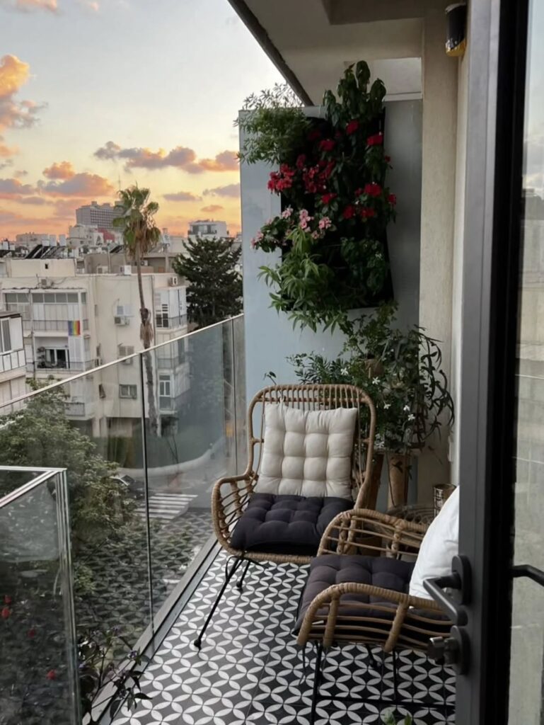 17. Rattan Chair Balcony with Graphic Tile Floor, Flower Wall Planter, and Sunset City View