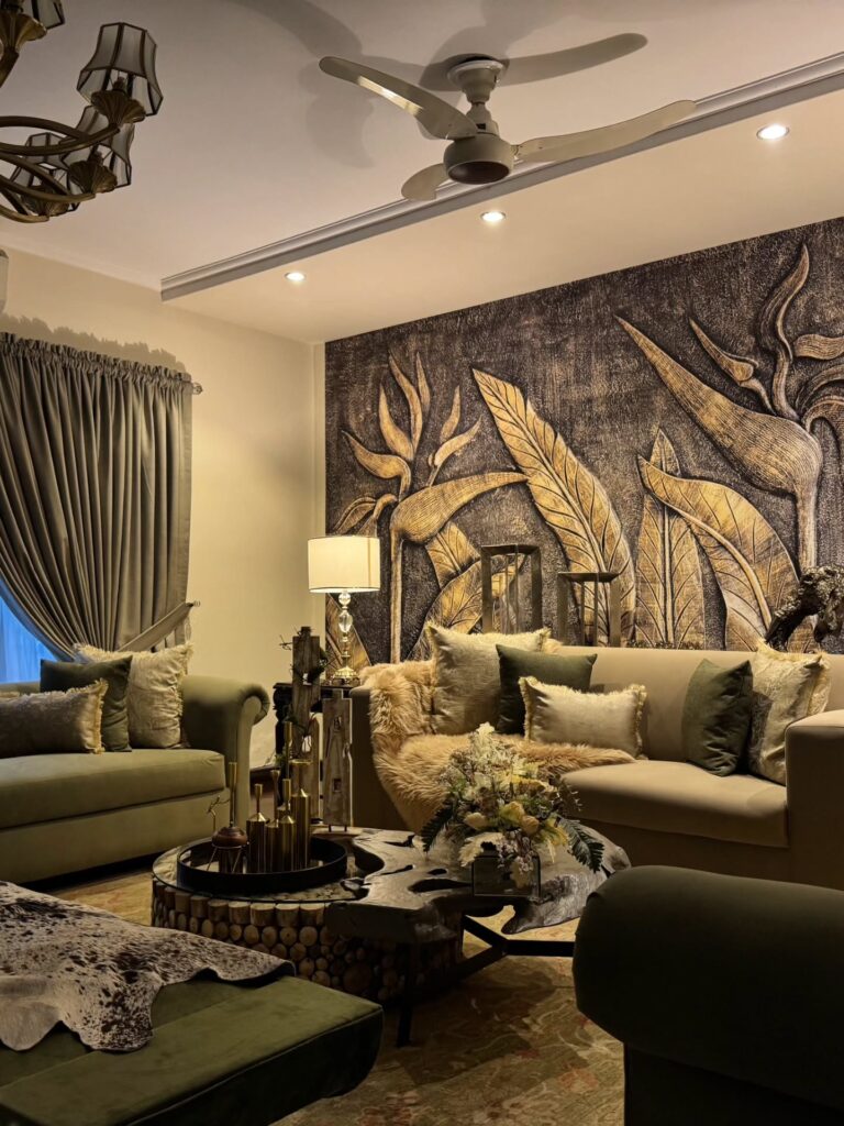 11. Raised Botanical Wall with Olive Sofas, Fur Throws, and Brass Table Accents