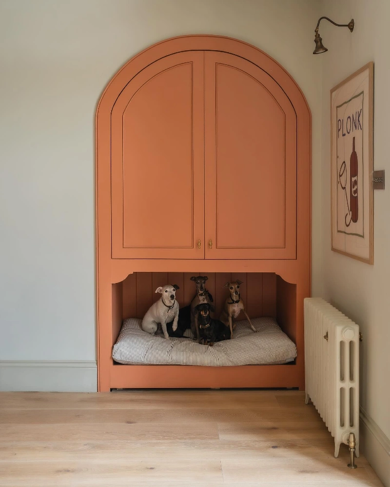Arched Coral Cabinetry with Integrated Pet Nook