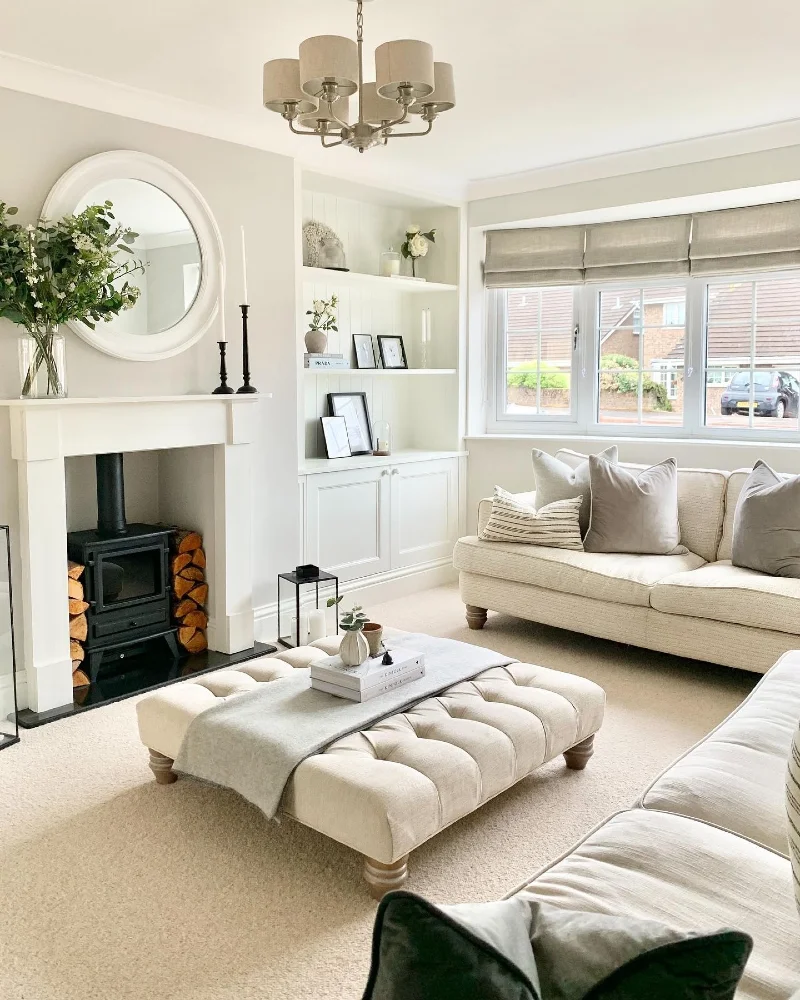 Arched Mirror Mantel with a Tufted Ottoman and Built-In Shelving