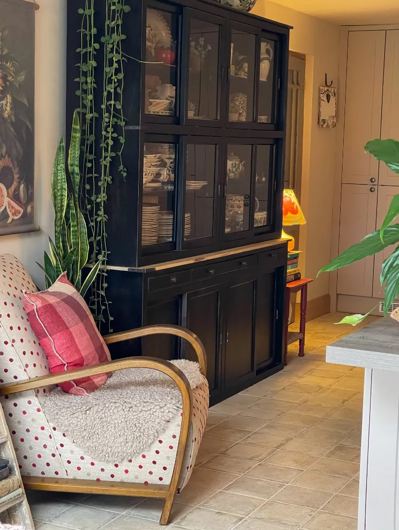 Black Painted Hutch with Polka Dot Armchair and Trailing Greenery