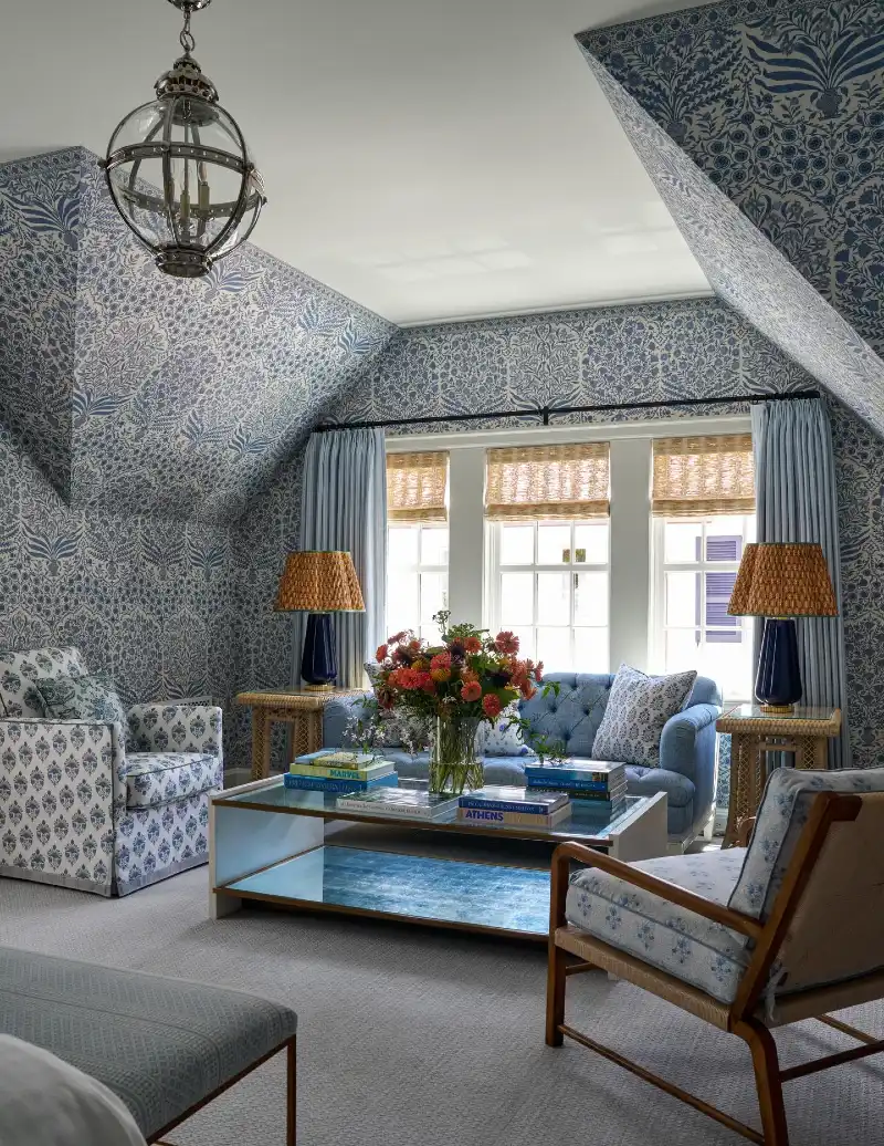 Blue Floral Wallpaper with Tufted Sofa and Wooden Armchair
