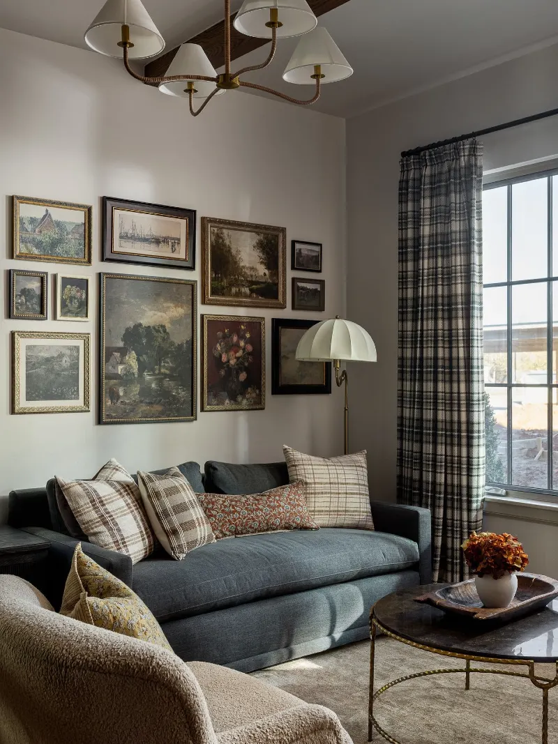 Blue-Gray Sofa with Bouclé Chair, Gallery Wall, and Plaid Curtains