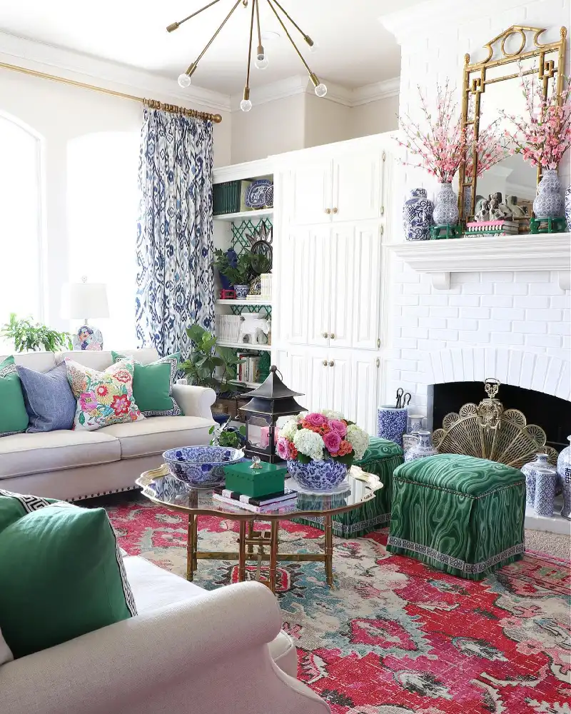 Bold Malachite Ottomans with Vibrant Floral Rug and Blue-and-White Porcelain