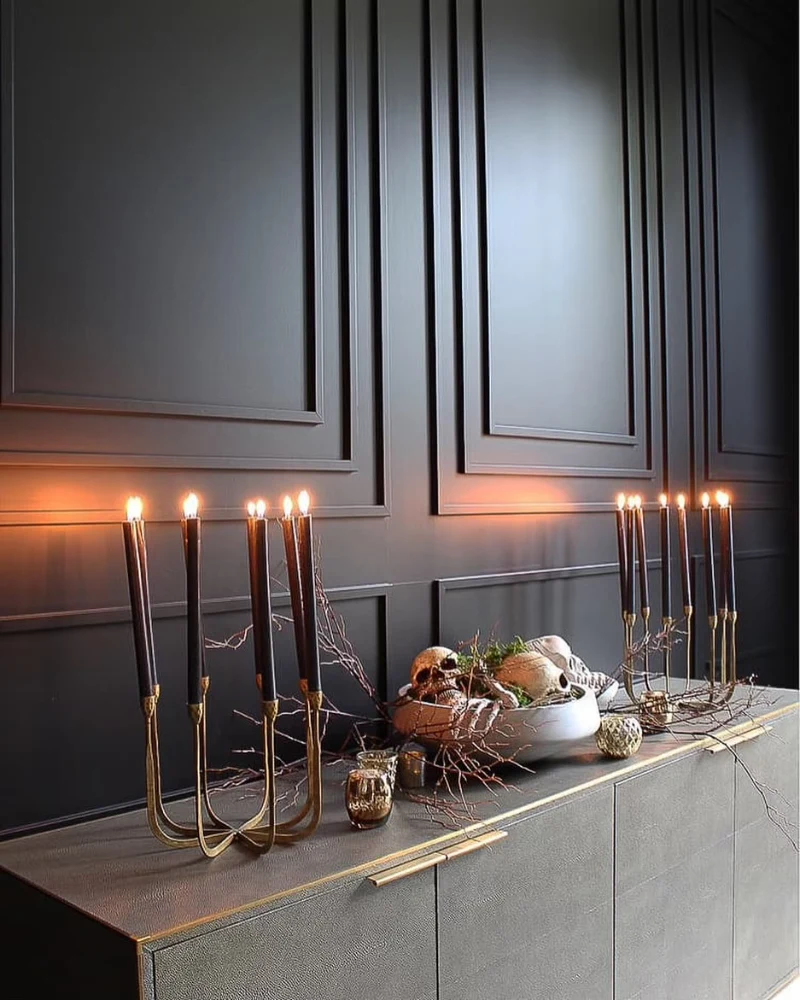 Brass Candelabras with Black Taper Candles on a Textured Charcoal Credenza