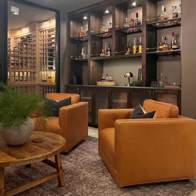 Brass Rail Bar Cabinet Next to a Glass Wine Cellar