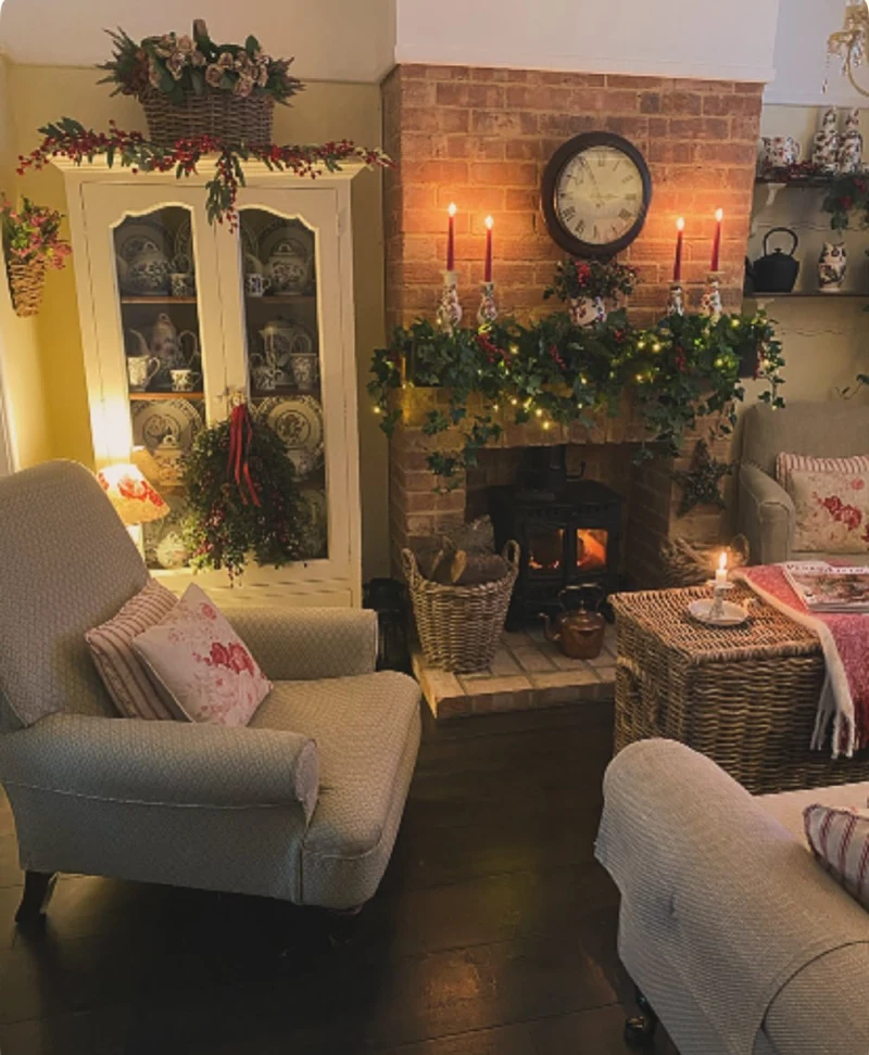 Brick Fireplace with Red Taper Candles, Lit Wood Stove, and White China Hutch