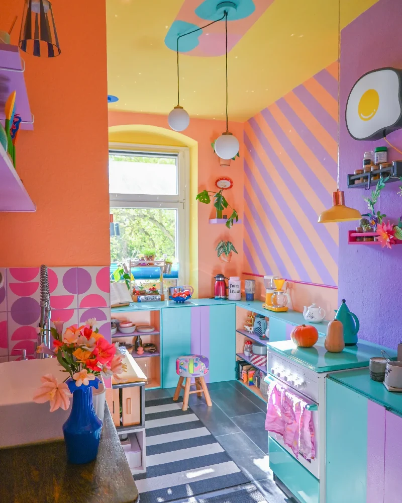 Candy-Colored Kitchen with Striped Walls and Vibrant Cabinetry