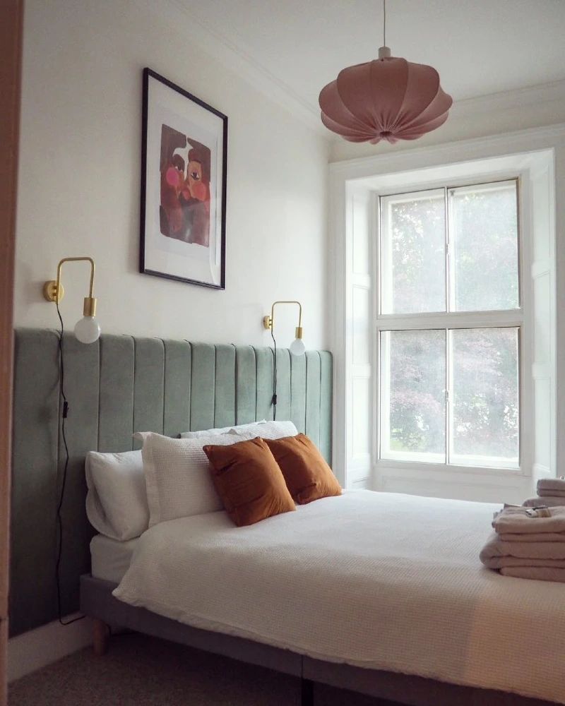 Channel-Tufted Velvet Panels with Brass Wall Sconces