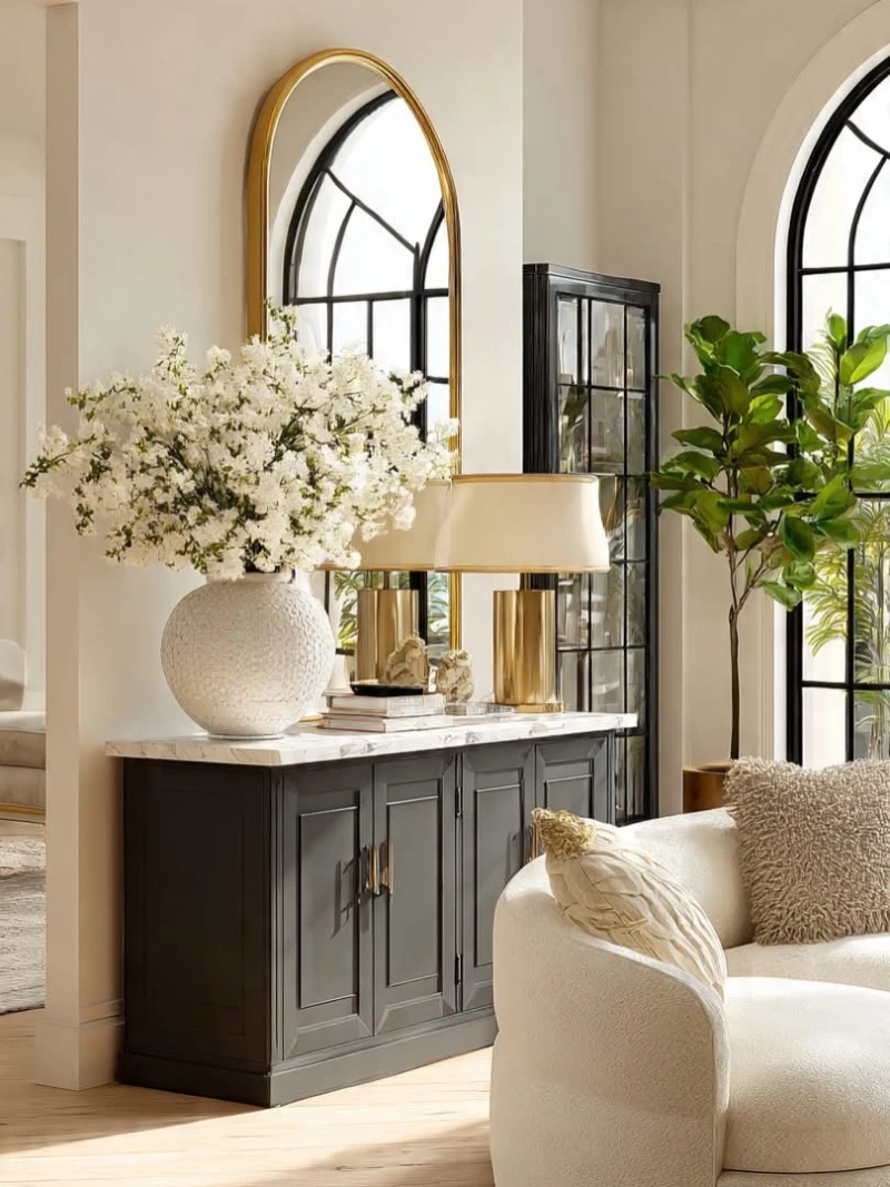 Charcoal Console with an Arched Gold Mirror and Oversized White Florals